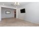 Bright living room featuring tile floors, recessed lighting, and a wall-mounted TV at 1557 Quail Vista Ct, Logandale, NV 89021