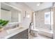 Bathroom with marble-style tiling in the shower/bath area, updated sink, and faucet fixtures at 1812 Renada Cir, North Las Vegas, NV 89030