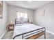 Cozy bedroom with neutral walls and minimalistic decor and a window at 1812 Renada Cir, North Las Vegas, NV 89030