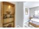 View from a hallway nook into a bedroom with simple décor and a metal bed frame at 1812 Renada Cir, North Las Vegas, NV 89030