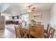 Open dining room with decorative area rug, ceiling fan, and access to the kitchen at 1812 Renada Cir, North Las Vegas, NV 89030