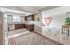 Well-lit kitchen with granite countertops, stainless appliances, and decorative area rug at 1812 Renada Cir, North Las Vegas, NV 89030