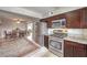 Bright kitchen showcasing stainless appliances and granite countertops open to the dining area at 1812 Renada Cir, North Las Vegas, NV 89030