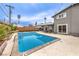 Charming backyard featuring a pool, patio, and lush tropical landscaping at 1812 Renada Cir, North Las Vegas, NV 89030