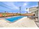 Spacious backyard with a sparkling pool, patio area, and lush landscaping at 1812 Renada Cir, North Las Vegas, NV 89030