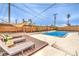 Outdoor pool area with lounge chairs and a modern wood fence at 1812 Renada Cir, North Las Vegas, NV 89030