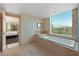 A luxurious bathtub with a view of the city skyline, adjacent to a glass shower at 2000 N Fashion Show Dr # 3307, Las Vegas, NV 89109