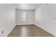 A bright bedroom boasts wood-look flooring and a large window, perfect for comfortable living at 2120 Ramrod Ave # 1318, Henderson, NV 89014