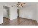 Empty bedroom with wood-style floors, ceiling fan, and access to bathroom and closet at 2120 Ramrod Ave # 1318, Henderson, NV 89014