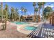 Resort-style community pool with jacuzzi, lounge chairs, and palm trees at 2120 Ramrod Ave # 1318, Henderson, NV 89014