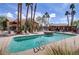 Community pool with mature palms and a shaded cabana at 2120 Ramrod Ave # 1318, Henderson, NV 89014