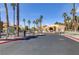 Gated entrance to a community with palm trees and well-maintained landscaping at 2120 Ramrod Ave # 1318, Henderson, NV 89014