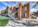 Attractive condominium complex with stucco exterior, tiled roof, and lush landscaping at 2120 Ramrod Ave # 1318, Henderson, NV 89014
