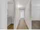Hallway with wood-look flooring, leading to a laundry room and other rooms at 2120 Ramrod Ave # 1318, Henderson, NV 89014