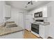 Well-lit kitchen featuring granite countertops, white cabinetry, and modern appliances for a delightful cooking experience at 2120 Ramrod Ave # 1318, Henderson, NV 89014