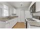 The kitchen has a granite counter, sink, stove, microwave, and refrigerator at 2120 Ramrod Ave # 1318, Henderson, NV 89014