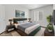 Beautifully staged main bedroom with plants, lamps, and picture art at 2120 Ramrod Ave # 1318, Henderson, NV 89014
