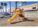 Community playground with a yellow slide and safe play area for children to enjoy at 2120 Ramrod Ave # 1318, Henderson, NV 89014