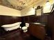 Elegant bathroom with a clawfoot tub, dark wood accents, and artistic ceiling detail at 26 E Serene Ave # 412, Las Vegas, NV 89123