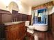 Bathroom with a steam shower, custom cabinet sink, toilet, and dark wood paneling at 26 E Serene Ave # 412, Las Vegas, NV 89123