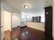 Upstairs bonus room with hardwood floors, iron railing, and a view of the downstairs living space at 26 E Serene Ave # 412, Las Vegas, NV 89123