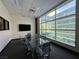 Bright conference room featuring a glass table, comfortable chairs, and large windows at 26 E Serene Ave # 412, Las Vegas, NV 89123