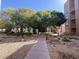 Exterior view of property featuring modern architecture and mature trees at 26 E Serene Ave # 412, Las Vegas, NV 89123