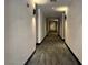 A well lit hallway with neutral colors and plush carpeting at 26 E Serene Ave # 412, Las Vegas, NV 89123