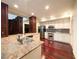 Spacious kitchen with stainless steel appliances, center island, and dark wood flooring at 26 E Serene Ave # 412, Las Vegas, NV 89123