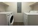 Laundry room featuring a washer, dryer, and built-in shelving at 26 E Serene Ave # 412, Las Vegas, NV 89123