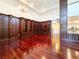 An open-concept living room featuring hardwood floors, high ceilings, and custom built-in shelving at 26 E Serene Ave # 412, Las Vegas, NV 89123