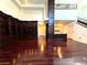 Open-concept living area with hardwood floors, built-in bookcase and access to kitchen at 26 E Serene Ave # 412, Las Vegas, NV 89123