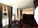 Spacious living room featuring high ceilings, gleaming hardwood floors, large windows with custom drapery, and built-in shelving at 26 E Serene Ave # 412, Las Vegas, NV 89123