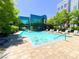 Community swimming pool with lounge chairs and a modern building backdrop at 26 E Serene Ave # 412, Las Vegas, NV 89123