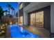 Contemporary home featuring a stylish pool, modern design, and an open view into the living area through large windows at 2819 Queens Courtyard Dr, Las Vegas, NV 89109