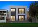 Contemporary two-story home featuring a modern design with a mix of light and dark exterior colors at 2819 Queens Courtyard Dr, Las Vegas, NV 89109