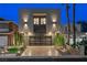 Contemporary home featuring a modern design with a glass garage door and minimalist landscaping at 2819 Queens Courtyard Dr, Las Vegas, NV 89109