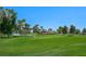 Expansive view of the lush green golf course with a pond and a distant clubhouse at 2819 Queens Courtyard Dr, Las Vegas, NV 89109