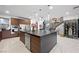Open-concept kitchen with a large island, stainless steel appliances, and a wine cellar, perfect for entertaining at 2819 Queens Courtyard Dr, Las Vegas, NV 89109