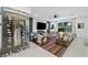 Bright living room featuring a modern fireplace, comfortable seating, and a glass-enclosed wine display at 2819 Queens Courtyard Dr, Las Vegas, NV 89109