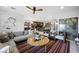 Open living space with patterned rug, comfortable seating and views of the kitchen and bar area at 2819 Queens Courtyard Dr, Las Vegas, NV 89109
