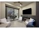 Relaxing patio featuring comfortable seating, an electric fireplace, and a view through sliding glass doors to a dining area at 2819 Queens Courtyard Dr, Las Vegas, NV 89109