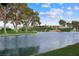 Scenic pond featuring a fountain and lush landscaping, near the golf course clubhouse at 2819 Queens Courtyard Dr, Las Vegas, NV 89109