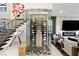 Modern wine cellar adjacent to staircase and featuring glass enclosure for storage at 2819 Queens Courtyard Dr, Las Vegas, NV 89109