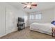 Inviting bedroom features a ceiling fan, closet, window with shutter-style shades, and television at 2831 Geary Pl # 2912, Las Vegas, NV 89109