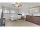 Bright bedroom features a ceiling fan, closet, dresser, and window with shutter-style shades at 2831 Geary Pl # 2912, Las Vegas, NV 89109
