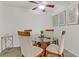 Inviting dining area with a glass-top table, comfortable seating, decorative art, and a modern ceiling fan at 2831 Geary Pl # 2912, Las Vegas, NV 89109
