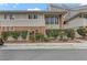 Multi-Gathering home featuring brick accents, complemented by lush landscaping and mature hedges at 2831 Geary Pl # 2912, Las Vegas, NV 89109