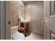 This charming bathroom has tile walls, a pedestal sink, and a convenient small wood storage rack at 2917 Chapala Dr, Las Vegas, NV 89120