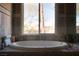 Bathroom with tiled walls, oversized tub and large window at 2917 Chapala Dr, Las Vegas, NV 89120